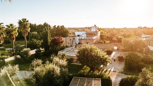 an aerial view of a building in a park with trees at Masseria La Tofala benessere & SPA in Copertino