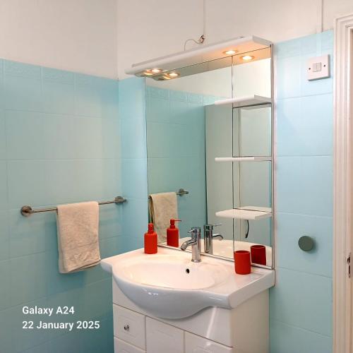 a bathroom with a sink and a mirror at The Coral House in Rivière Noire