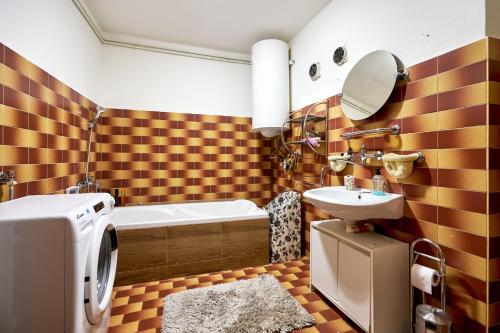 a bathroom with a tub and a sink and a toilet at Devils Peak Prague in Prague