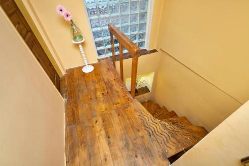 a wooden stairway with a vase of flowers on the wall at Devils Peak Prague in Prague
