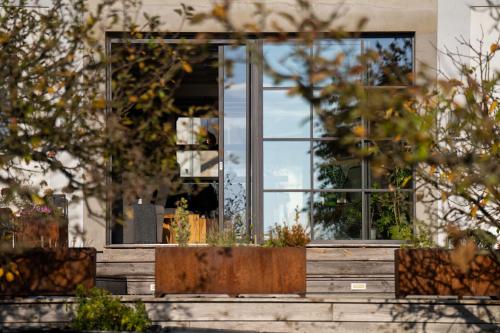 a window on a house with plants in the front at Hotel Grunt in Mladá Boleslav
