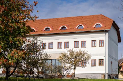 a large white building with a red roof at Hotel Grunt in Mladá Boleslav