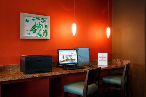 a desk with a computer and a printer and chairs at Residence Inn La Mirada Buena Park in La Mirada