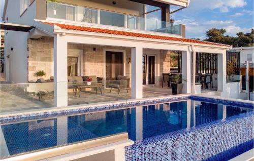 a house with a swimming pool in front of a house at Villa Miracle in Split