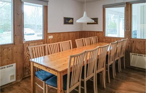 a dining room with a wooden table and chairs at Gorgeous Home In Köpingsvik With Sauna in Köpingsvik