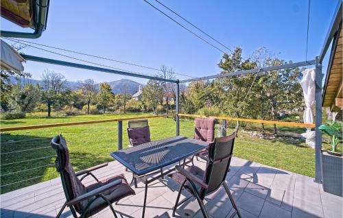 a patio with a table and chairs on a balcony at Nice Home In Licka Jesenica With Sauna in Lička Jesenica