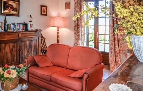 a living room with a red couch and a window at Amazing Home In Bassillac-Et-Auberoche in Le Change