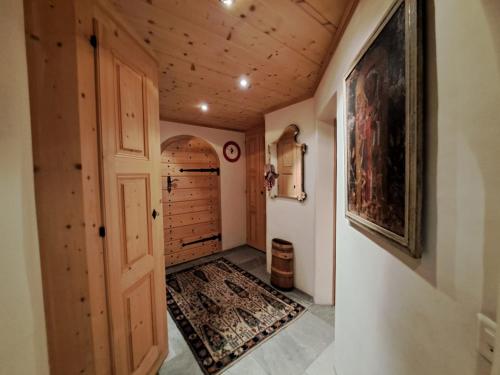a hallway of a home with a door and a rug at Laax Chalet by Quokka 360 - Charming Chalet with private patio in Laax