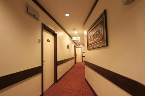 a corridor of a hallway with a red carpet at Ming Paragon Hotel in Kuala Terengganu