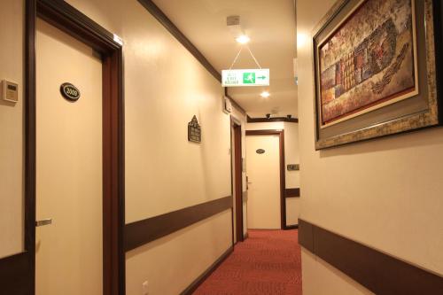 a corridor of a hospital hallway with a sign on the wall at Ming Paragon Hotel in Kuala Terengganu