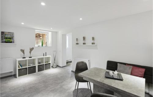 a living room with a table and a couch at 1 Bedroom Lovely Apartment In Nieheim in Nieheim