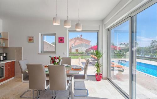 a kitchen and dining room with a table and chairs at Villa Anzela in Pula