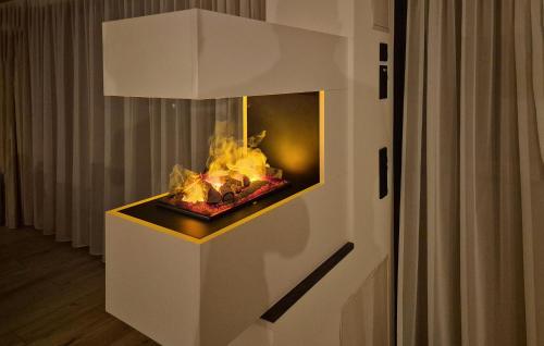 a fireplace in a living room with a fire in it at Prora Solitaire Avida Loft15 in Binz