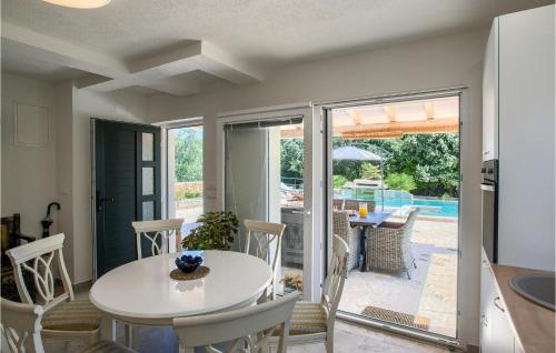 a kitchen and dining room with a white table and chairs at Villa Punte Bianche in Zadar