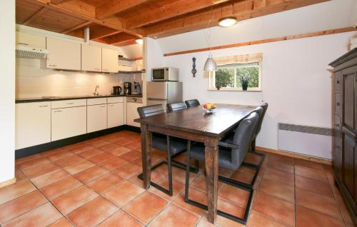 a kitchen with a wooden table and chairs at Gorgeous Home In Ijhorst With Wifi in IJhorst