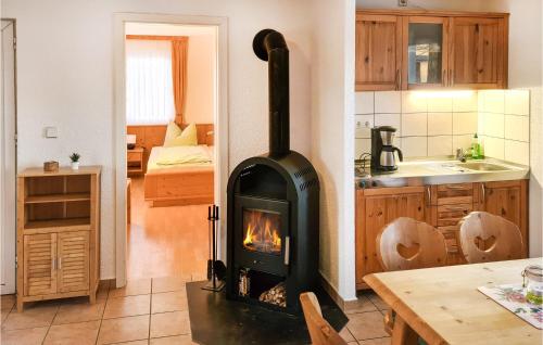a kitchen with a stove in the middle of a room at Holiday Home Hauptstrasse B in Eichigt