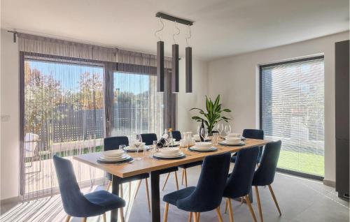 a dining room with a wooden table and chairs at Villa Dolcea in Umag