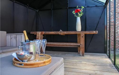 a table with a bottle of wine and a glass at Amazing Home In Diksmuide With Wifi in Diksmuide