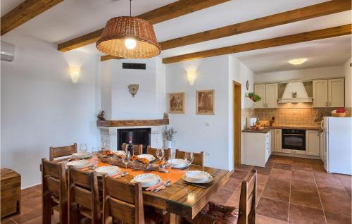 a kitchen and dining room with a table and chairs at Villa Loverka in Pula