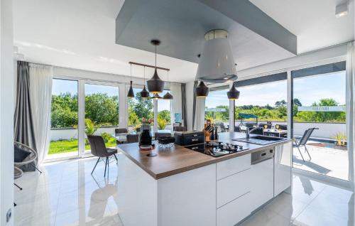 a kitchen with white cabinets and a view of the ocean at Villa Evoque in Bibinje