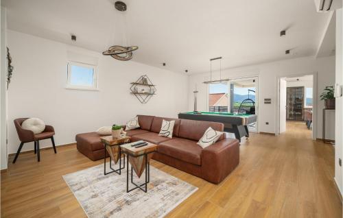 a living room with a couch and a pool table at Stunning Home In Zaboric With Sauna in Zaboric