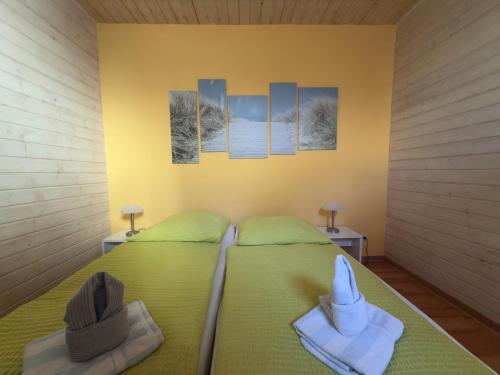 a bedroom with two beds with hats on them at Ferienwohnungen Alte Bäckerei in Rostock