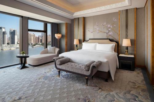 a bedroom with a bed and a large window at The St. Regis on the Bund, Shanghai in Shanghai