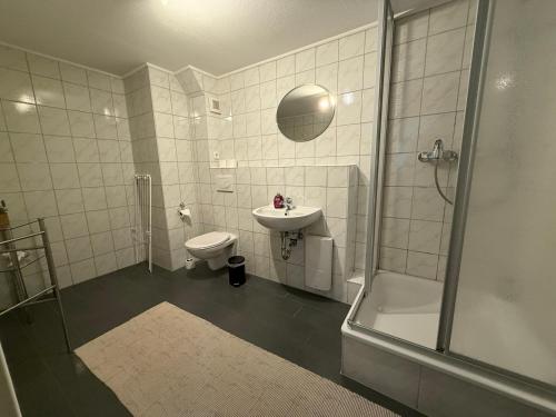 a bathroom with a shower and a toilet and a sink at Ferienwohnungen Alte Bäckerei in Rostock