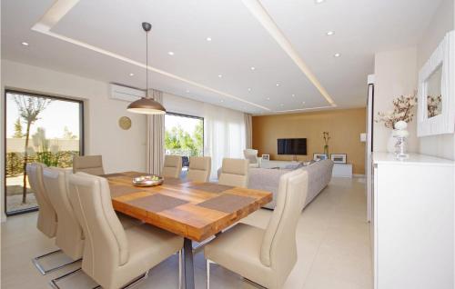 a dining room with a wooden table and chairs at Villa Olive Hill in Makarska