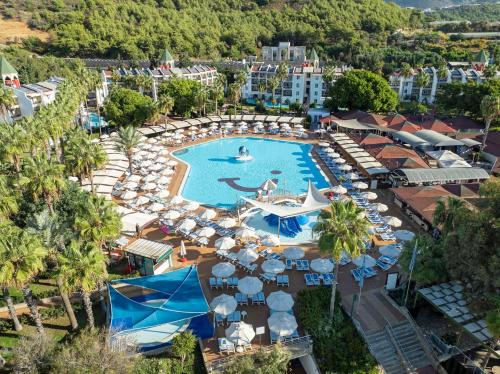 an aerial view of a resort pool with umbrellas and chairs at TUI BLUE Pascha Bay in Konaklı