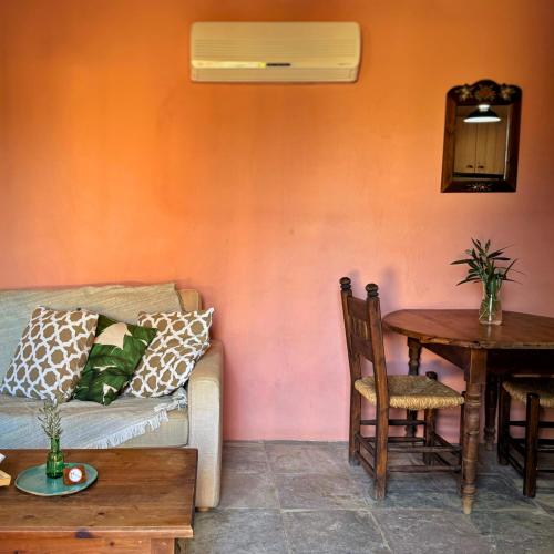 a living room with a couch and a table at Eveleos Country House in Tochni