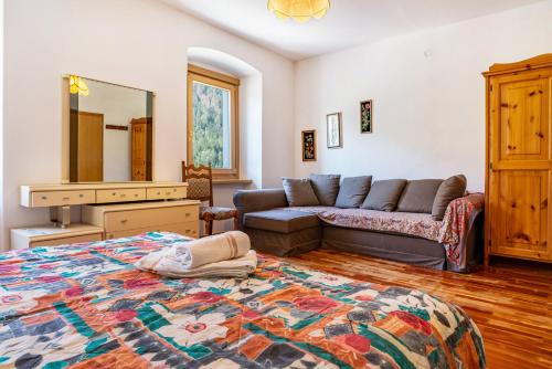 a living room with a bed and a couch at Casa Ai Laresi 1 in Peio