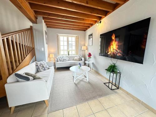 a living room with a couch and a fireplace at S Baylevéd'Air duplex vue château, Balnéo et sauna in Sedan