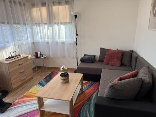 a living room with a couch and a coffee table at Nyugalom Kulcsa in Kulcs