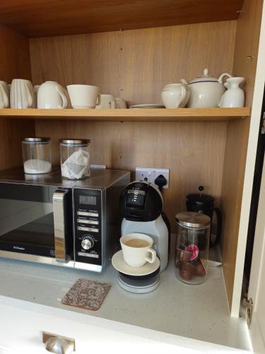 a kitchen with a coffee maker and a microwave at Three bedroom cosy quiet luxury in the Burren Wild Atlantic Way in Galway