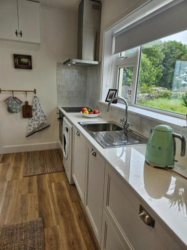 a kitchen with a sink and a window at Three bedroom cosy quiet luxury in the Burren Wild Atlantic Way in Galway