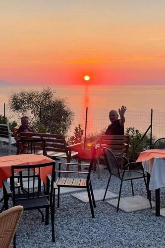 two people sitting on a bench watching the sunset at Villa Panorama in Zambrone