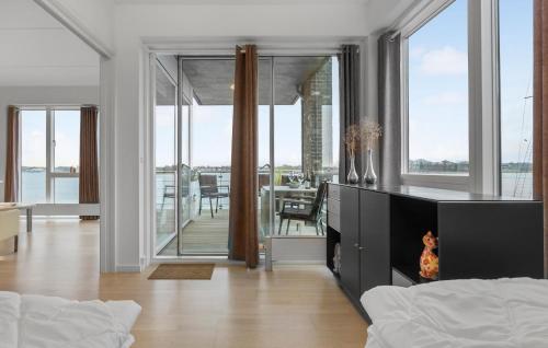 a living room with a fireplace and a dining room at Beautiful Apartment In Gråsten in Gråsten