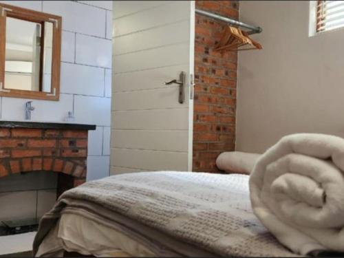 a room with a bed with a stone hand on it at Serendipity Guesthouse in Bloemfontein
