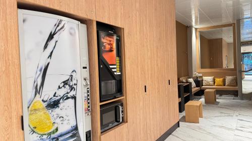une pièce avec une télévision à écran plat sur un mur dans l'établissement Hôtel Helvétique, à Nice