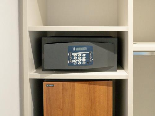 a microwave on a shelf in a closet at Hotel Marad in Torre del Greco