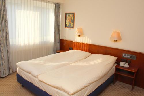 Cama o camas de una habitación en Elbroich Hotel Düsseldorf