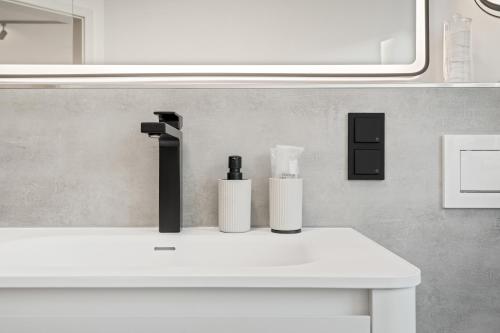 a bathroom with a white sink and a mirror at 1-2 Personen - Fahrradgarage - Küche - Zentrum - WLAN - Klima in Sankt Martin
