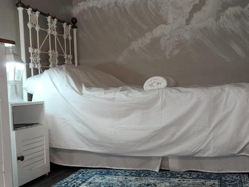 a bedroom with a white bed with a headboard at Serendipity Guesthouse in Bloemfontein