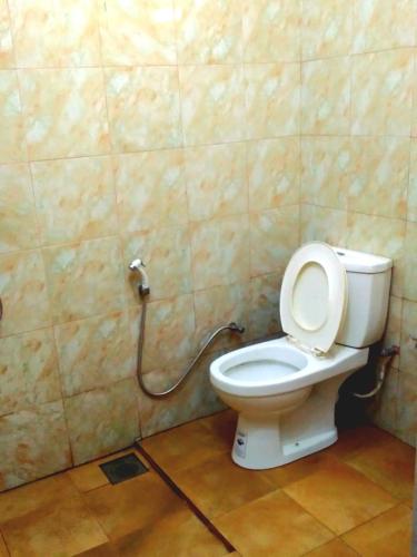 a bathroom with a toilet with a hose at Salmanel Resort Ayagama - Rathnapura in Ratnapura