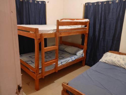 a couple of bunk beds in a room at Greenhub Transient House in San Juan