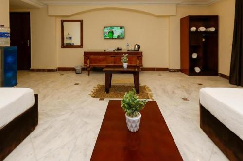 a living room with a table in the middle at Turquoise Pyramids palace in Giza