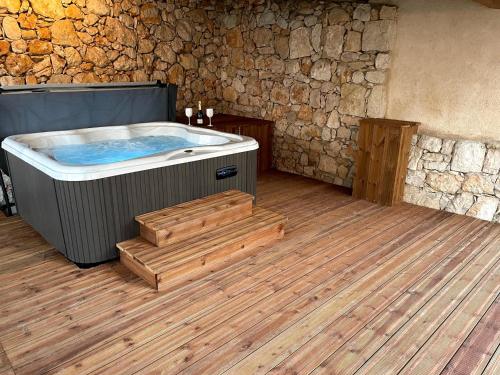 a hot tub in a room with a wooden floor at Le Mas de Camassade in Tourrettes-sur-Loup