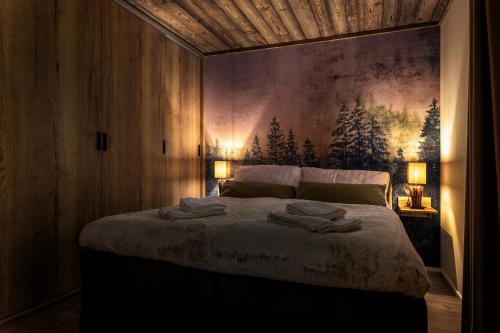 a bedroom with a bed with two towels on it at Mountain Apartment No 209-CORSO Harrachov, High Speed WI-FI, Ambilight smart TV, Netflix, YouTube, FREE parking, PRIVATE ski storage, "Ski-in Ski-out", HARRACHOVCARD in Harrachov