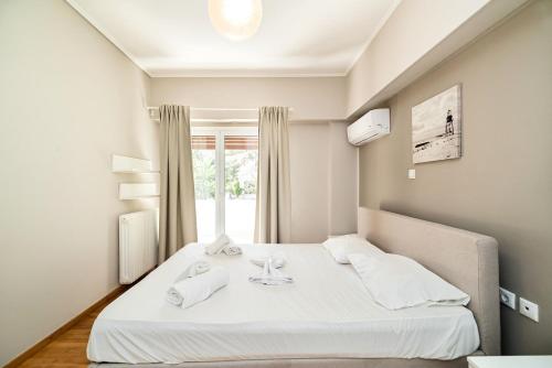 Ένα ή περισσότερα κρεβάτια σε δωμάτιο στο The Faliro Oasis